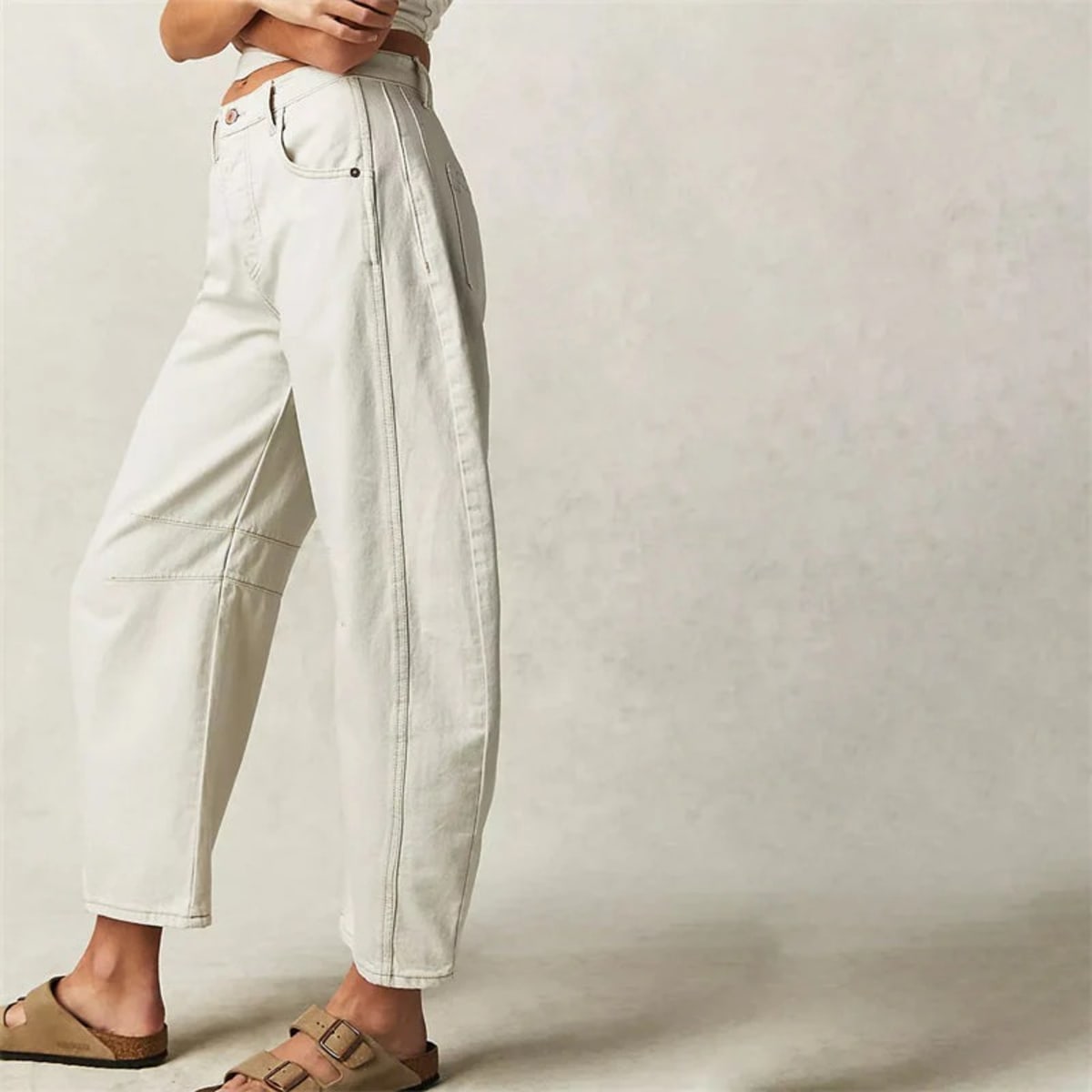 High-waisted barrel-leg jeans with seam detail.