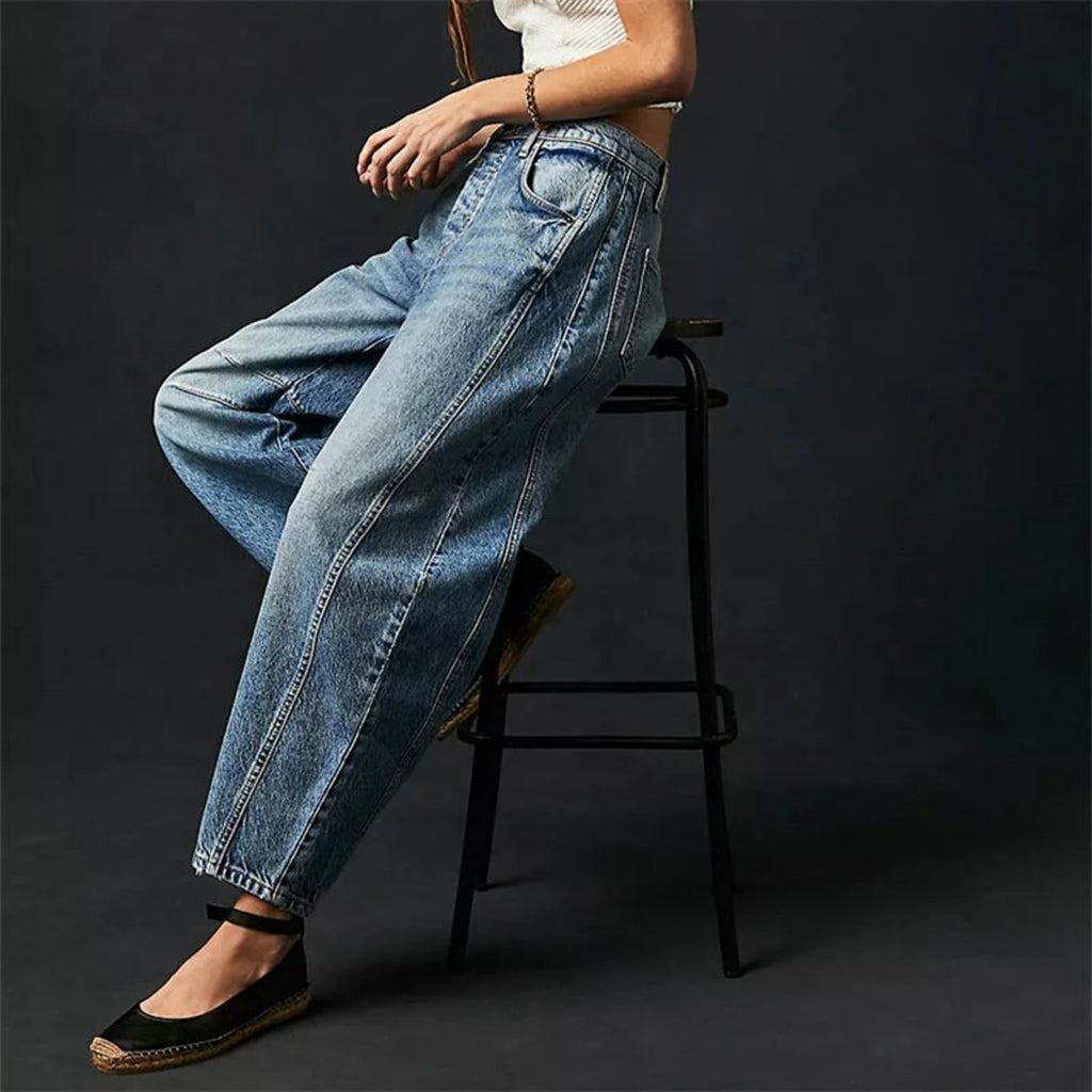 High-waisted barrel-leg jeans with seam detail.