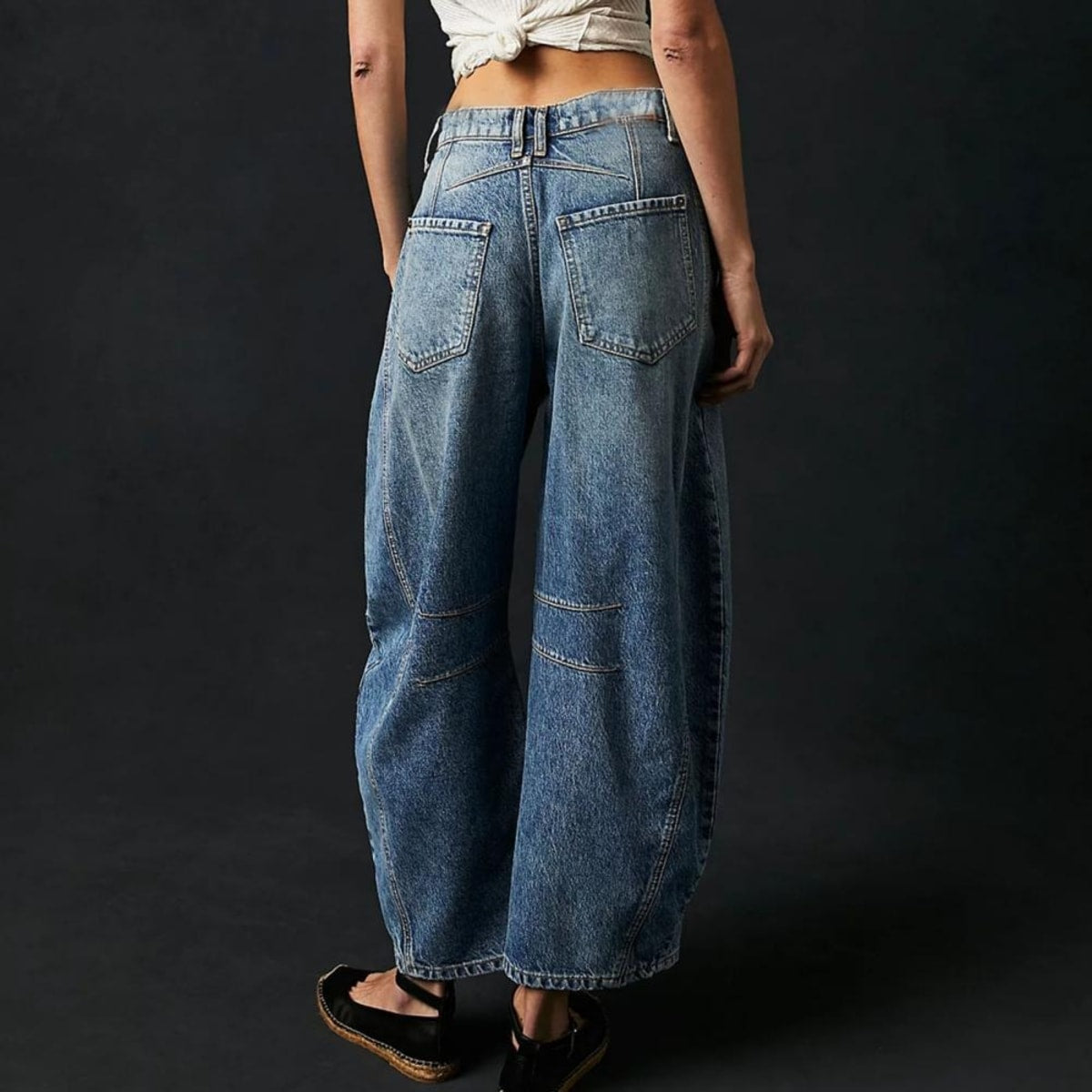 High-waisted barrel-leg jeans with seam detail.