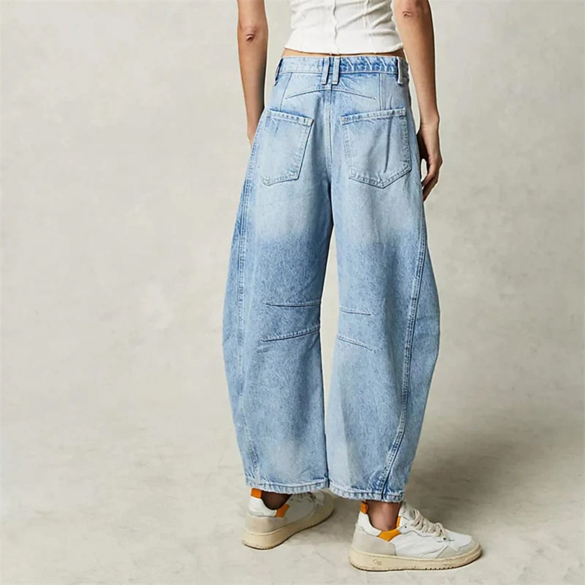 High-waisted barrel-leg jeans with seam detail.