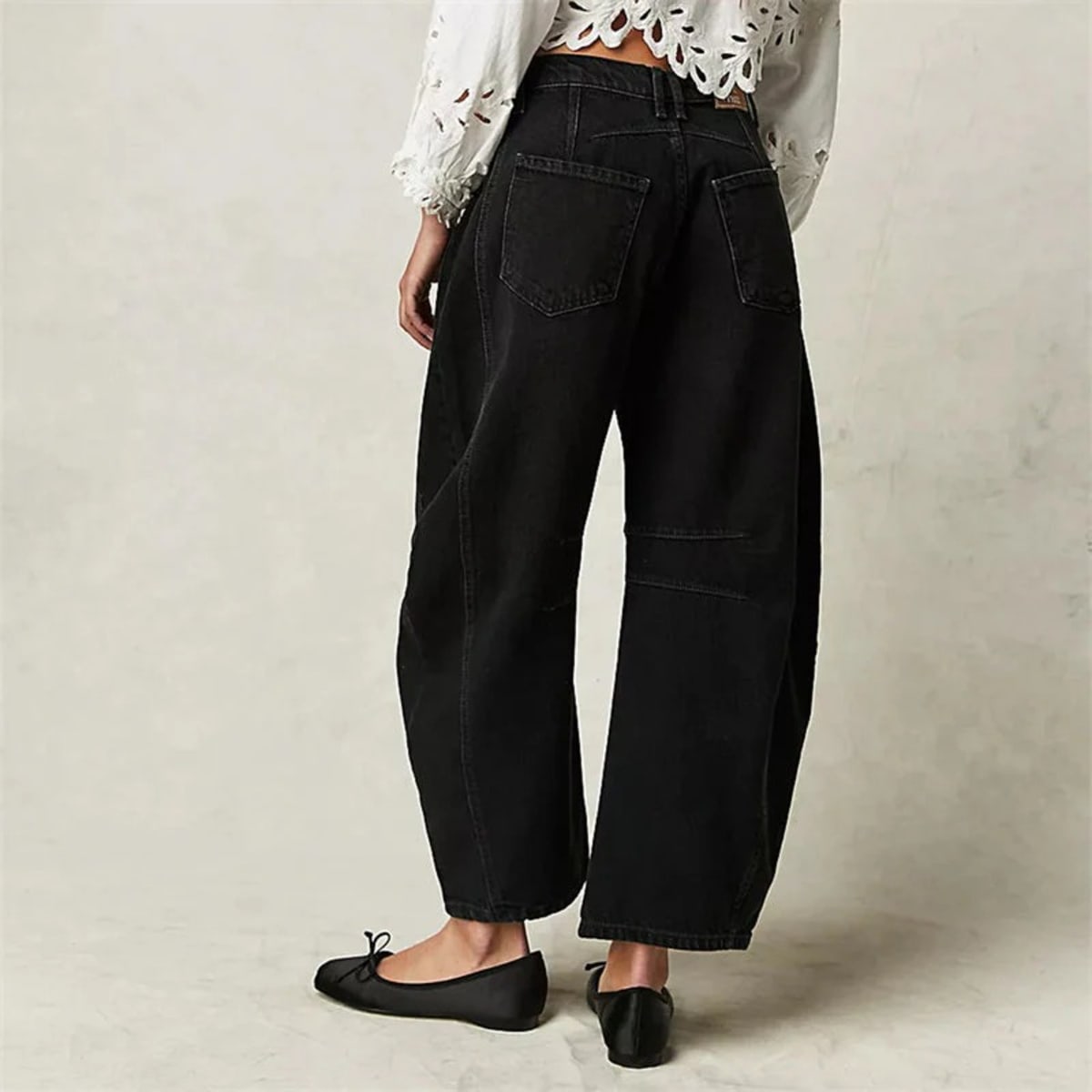 High-waisted barrel-leg jeans with seam detail.