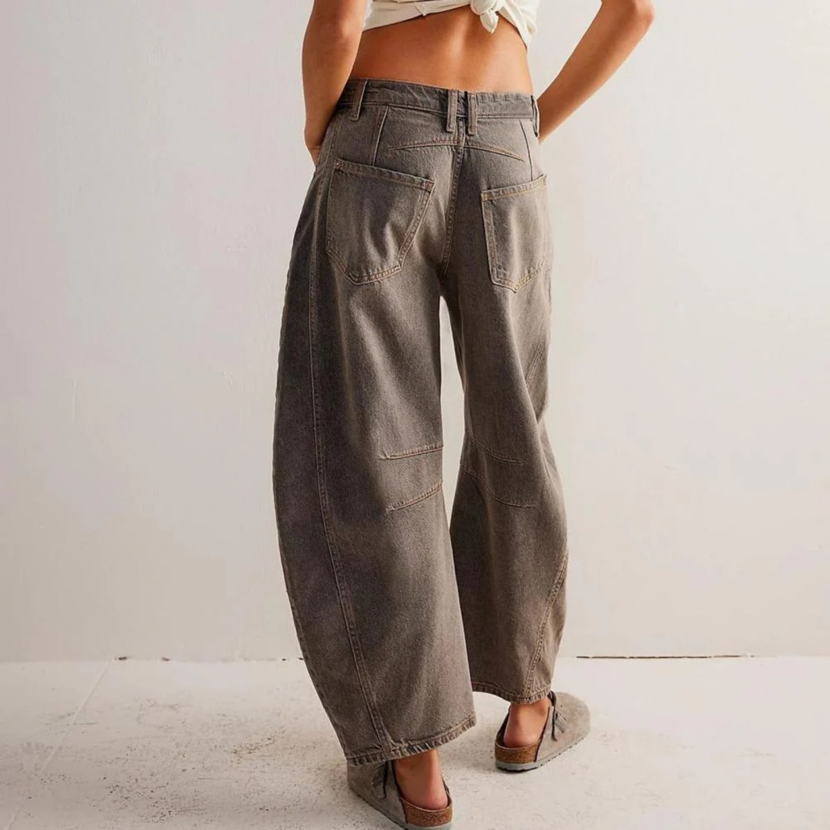 High-waisted barrel-leg jeans with seam detail.