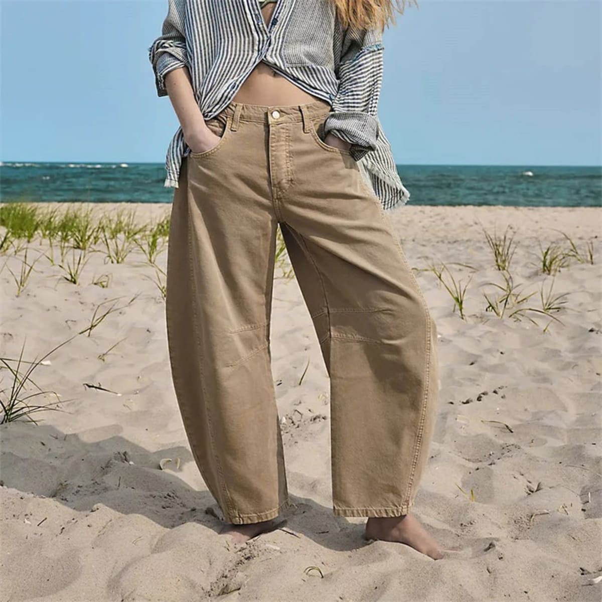 High-waisted barrel-leg jeans with seam detail.