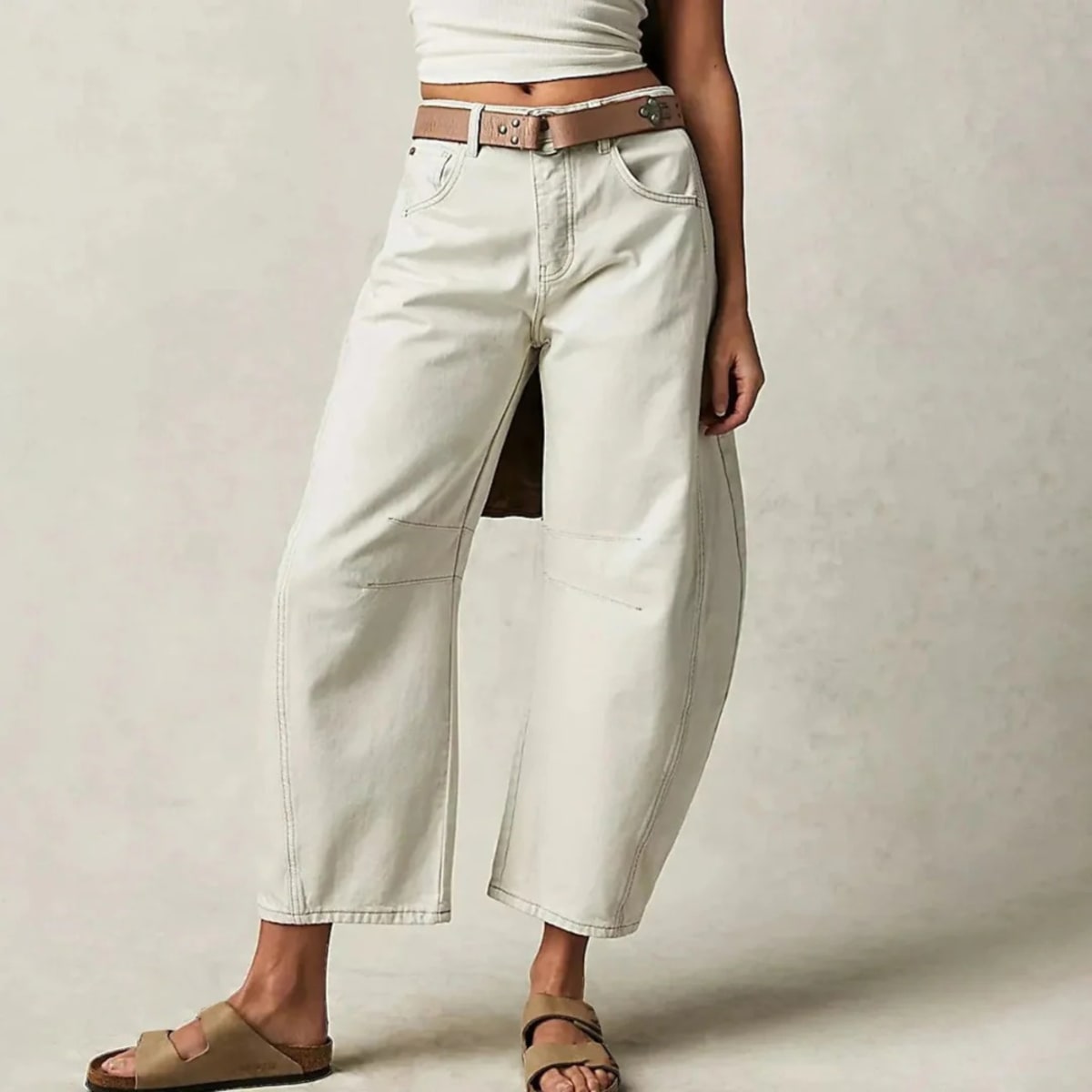 High-waisted barrel-leg jeans with seam detail.