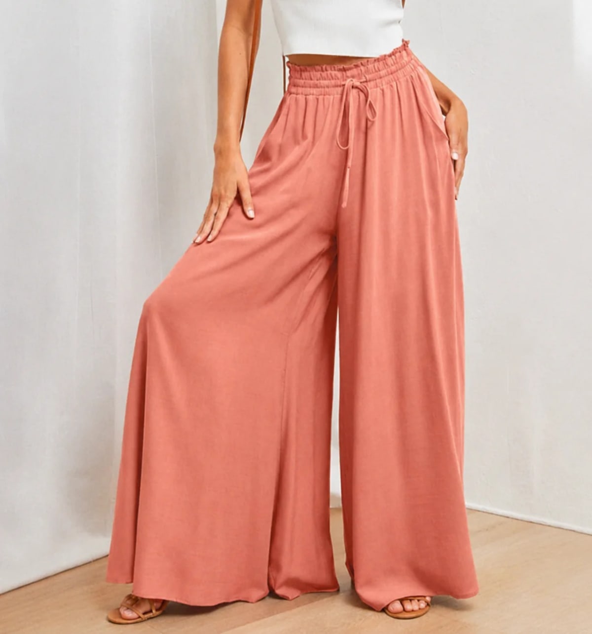 High-waisted wide-leg palazzo pants with drawstring waist.
