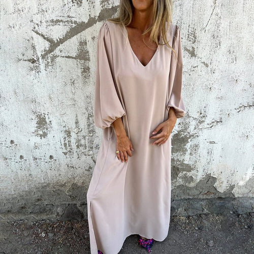 Flowing maxi dress with side slit and pockets.