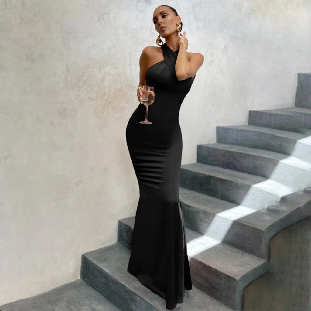 Fitted dress with open back and fishtail hem, formal wear.