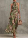 Woman in halter maxi dress with pleated bodice and waist tie