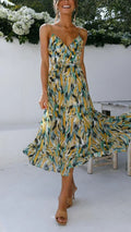 Woman wearing abstract printed midi dress with ruffle hem.