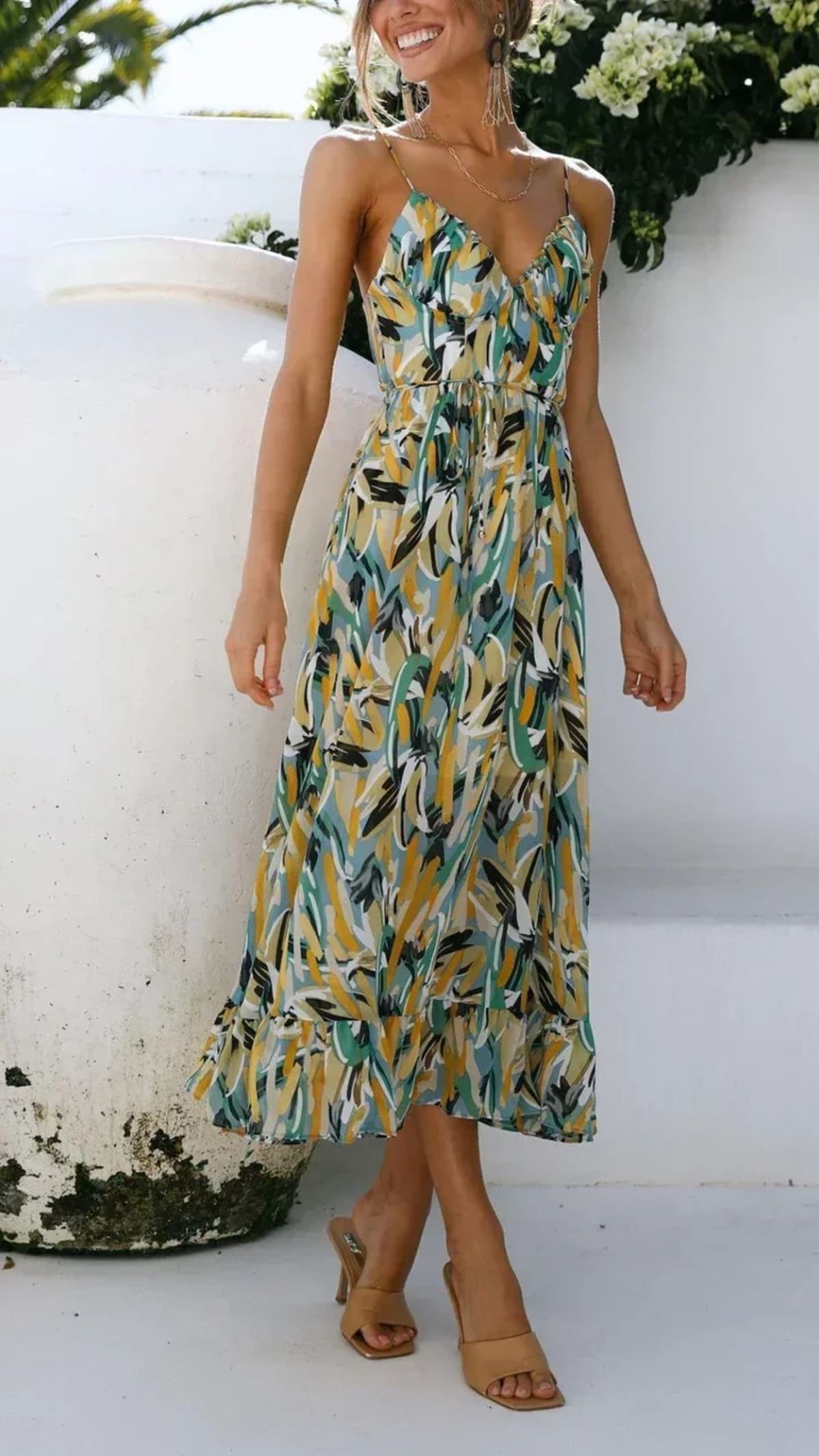 Woman wearing abstract printed midi dress with ruffle hem.