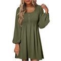 Women's smocked empire waist mini dress with long sleeves and buttons.
