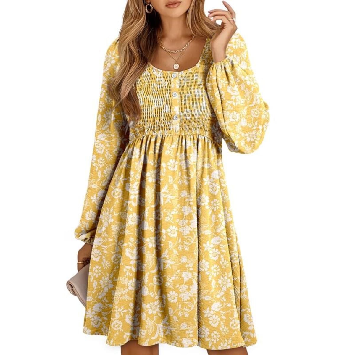 Women's smocked empire waist mini dress with long sleeves and buttons.