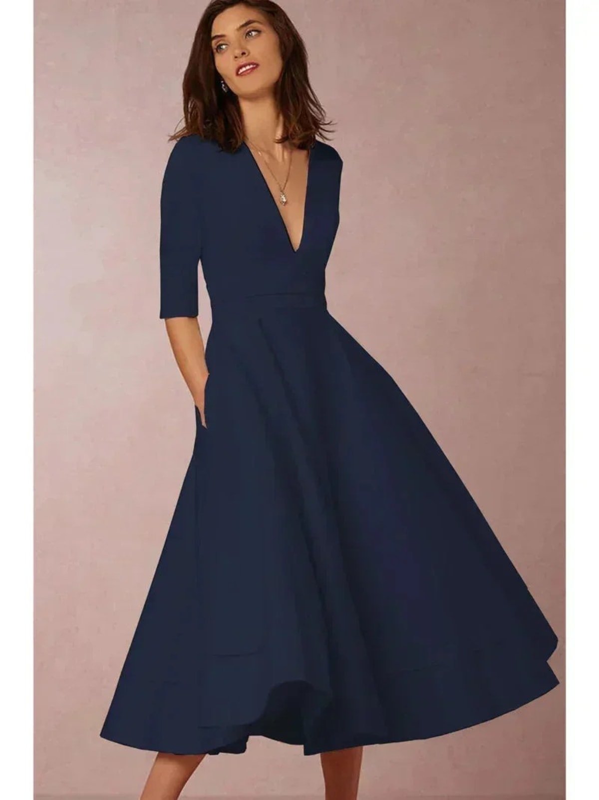 Woman in V-neck midi dress with 3/4 sleeves and pockets.