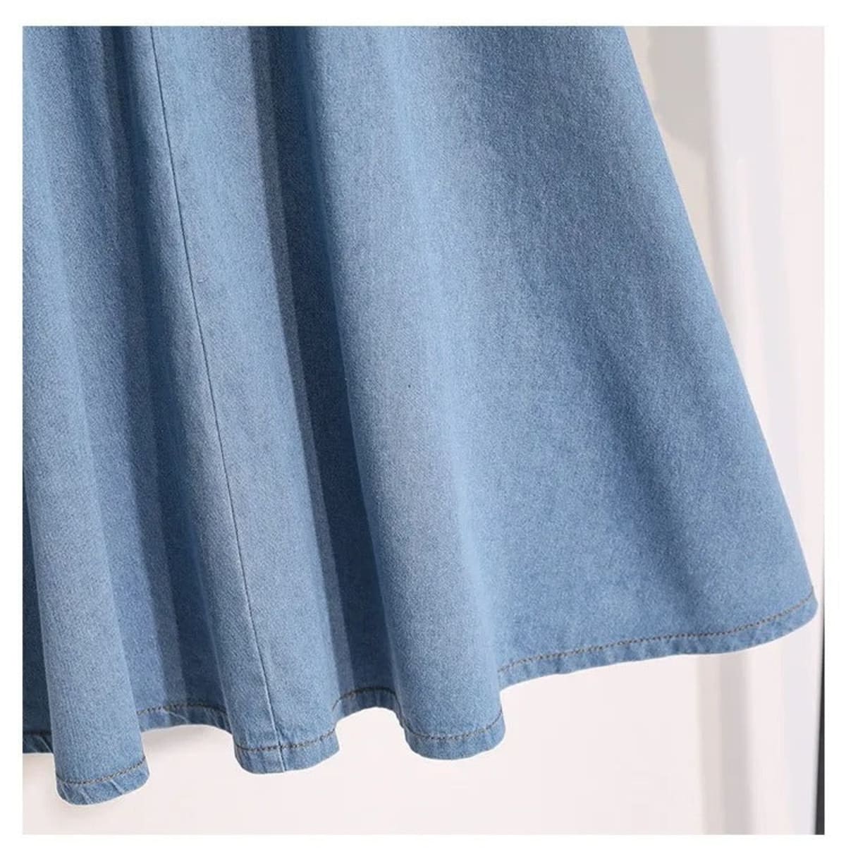 Light blue A-line midi skirt with button-front and elastic waist on hanger.