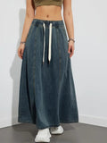 Person wearing a denim maxi skirt with elastic waist and drawstring.