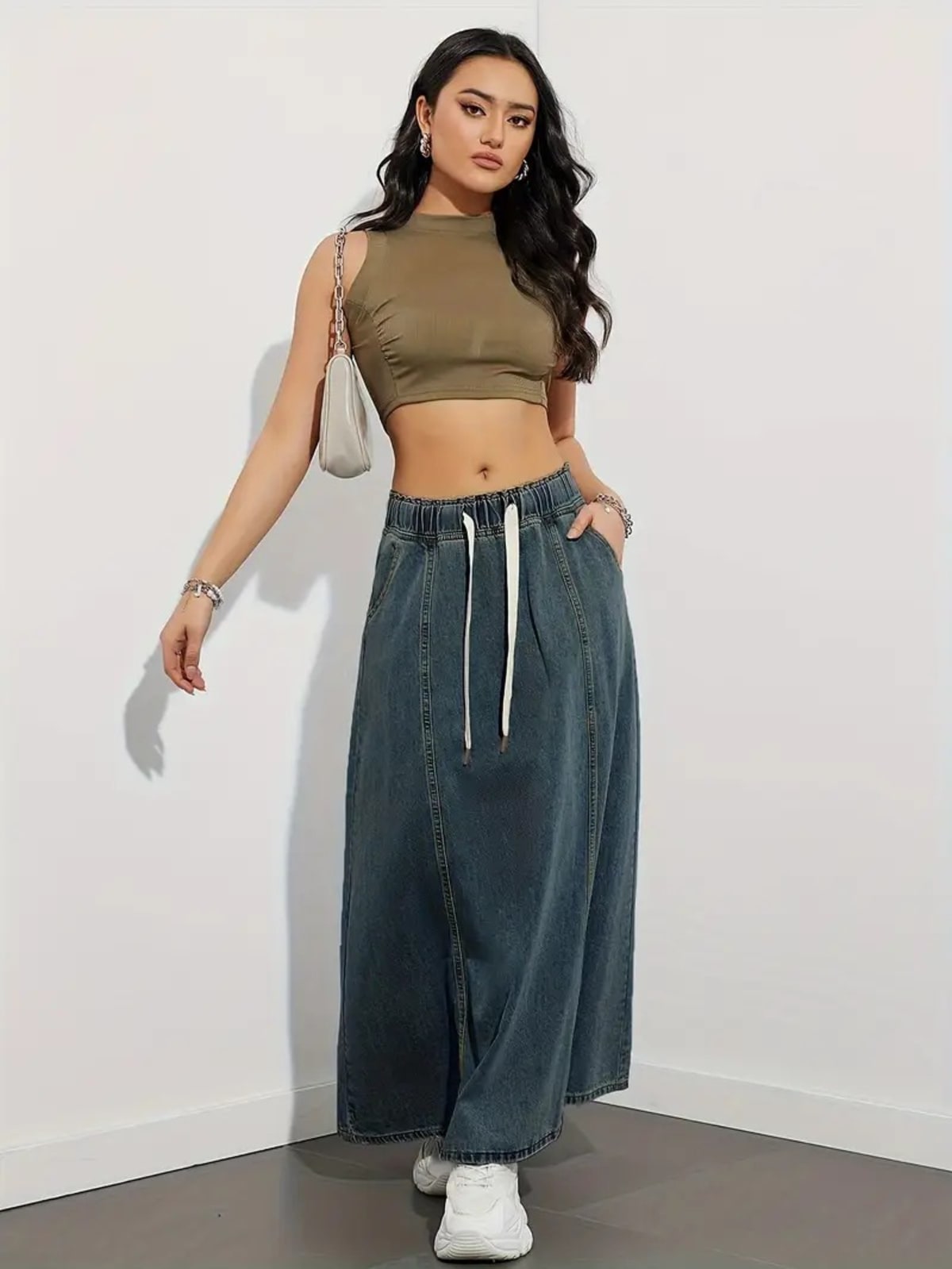 Person wearing a denim maxi skirt with elastic waist and drawstring.