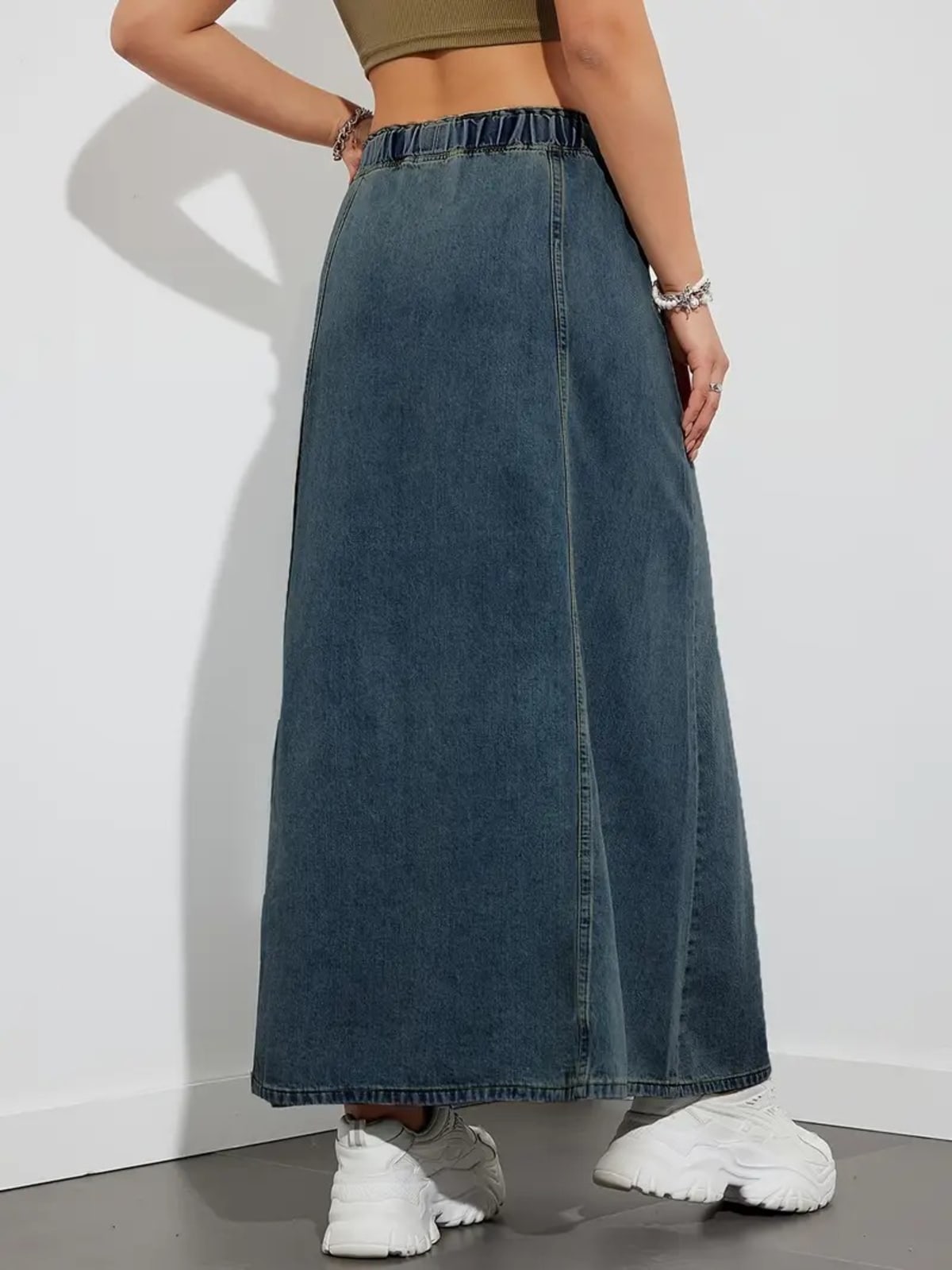 Person wearing a denim maxi skirt with elastic waist and drawstring.