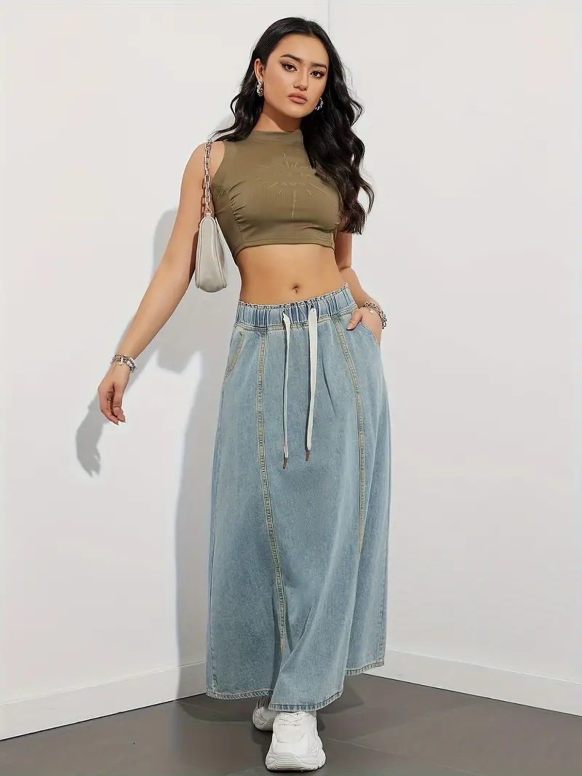 Person wearing a denim maxi skirt with elastic waist and drawstring.