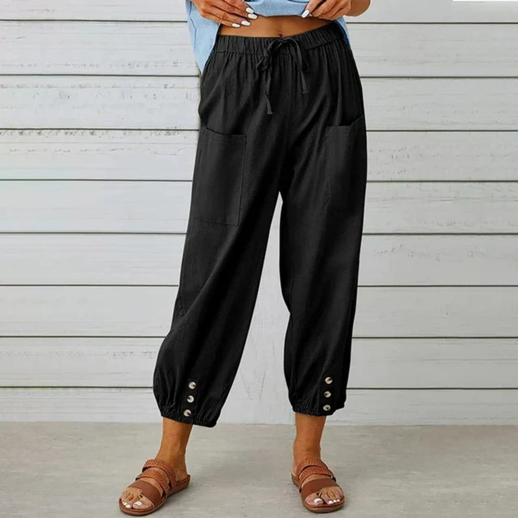 High-waisted relaxed pants with drawstring and ankle buttons.