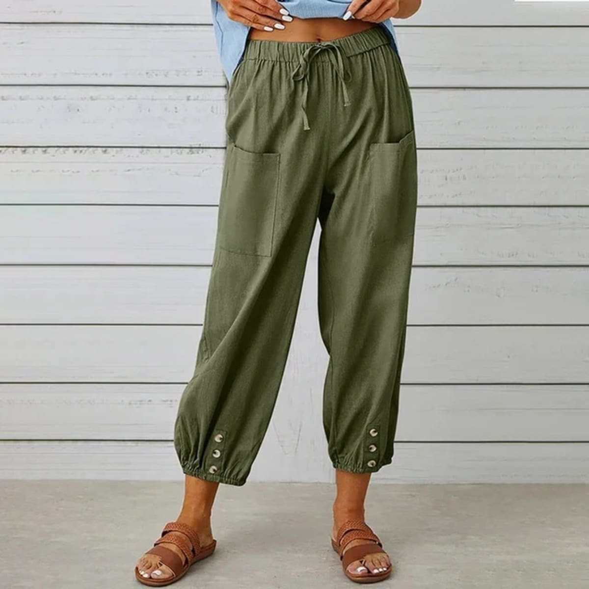 High-waisted relaxed pants with drawstring and ankle buttons.
