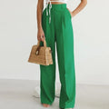 Women's high-waisted wide-leg pants with pleated details.