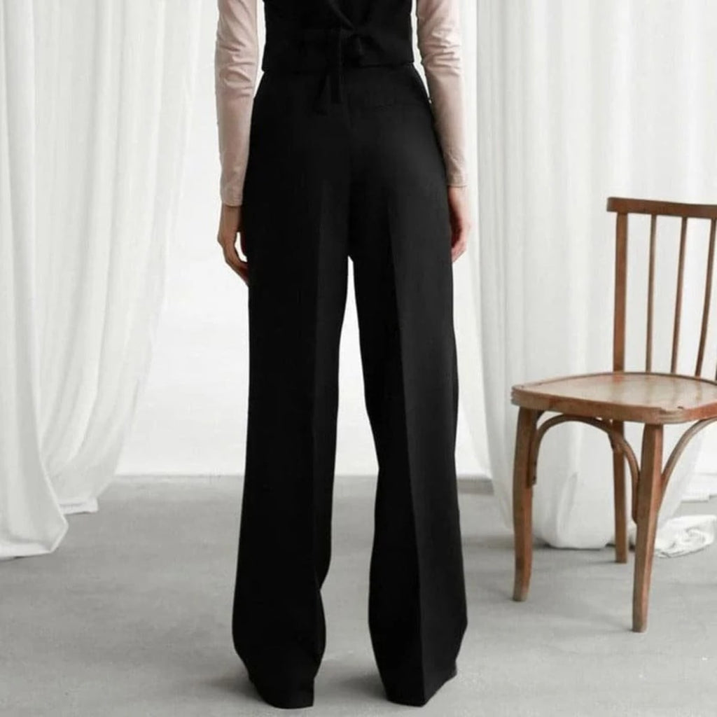 Women's high-waisted wide-leg pants with pleated details.