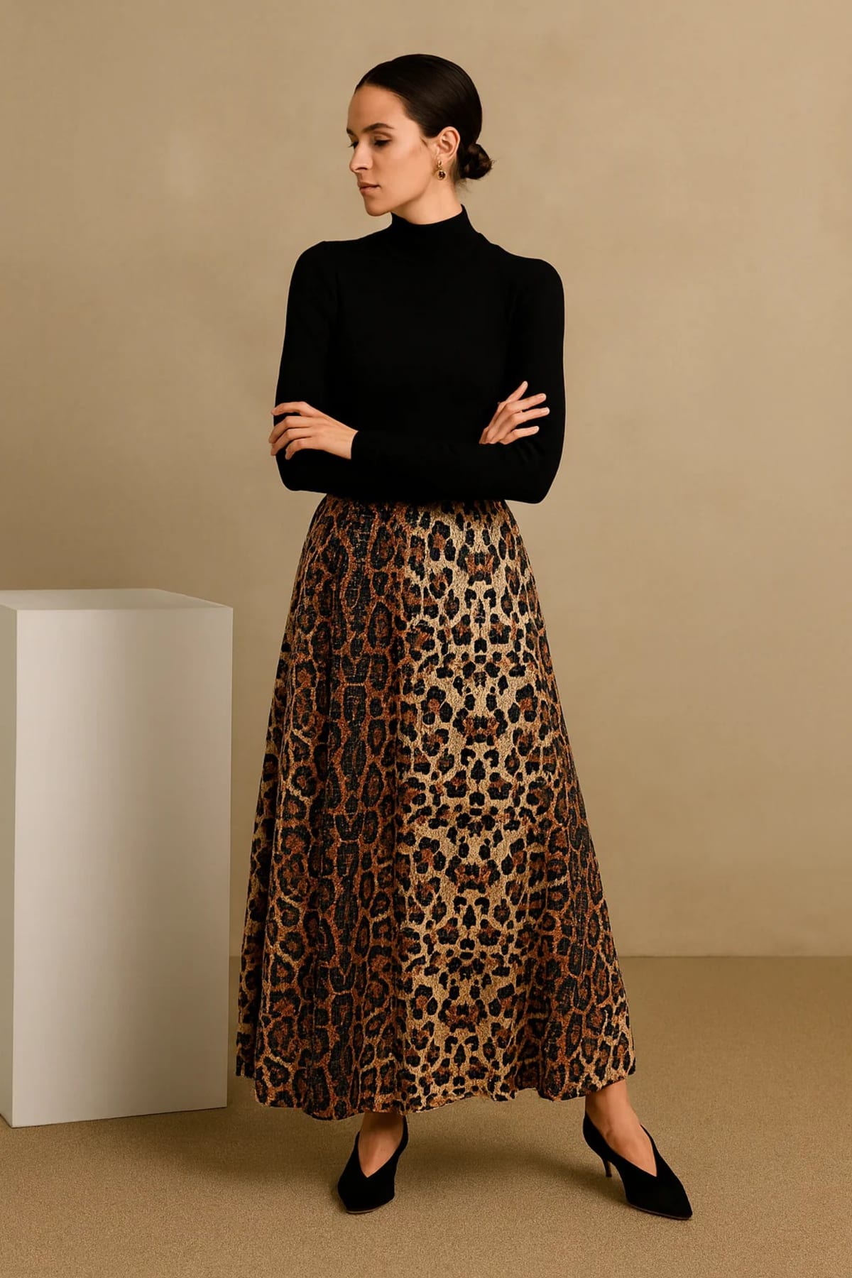 Model in leopard print maxi skirt with crossed arms.