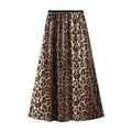 Model in leopard print maxi skirt with crossed arms.