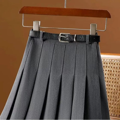 Pleated maxi skirt with belt displayed on a hanger.
