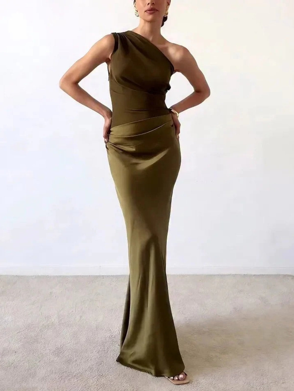 One-shoulder pleated maxi dress with asymmetric neckline.