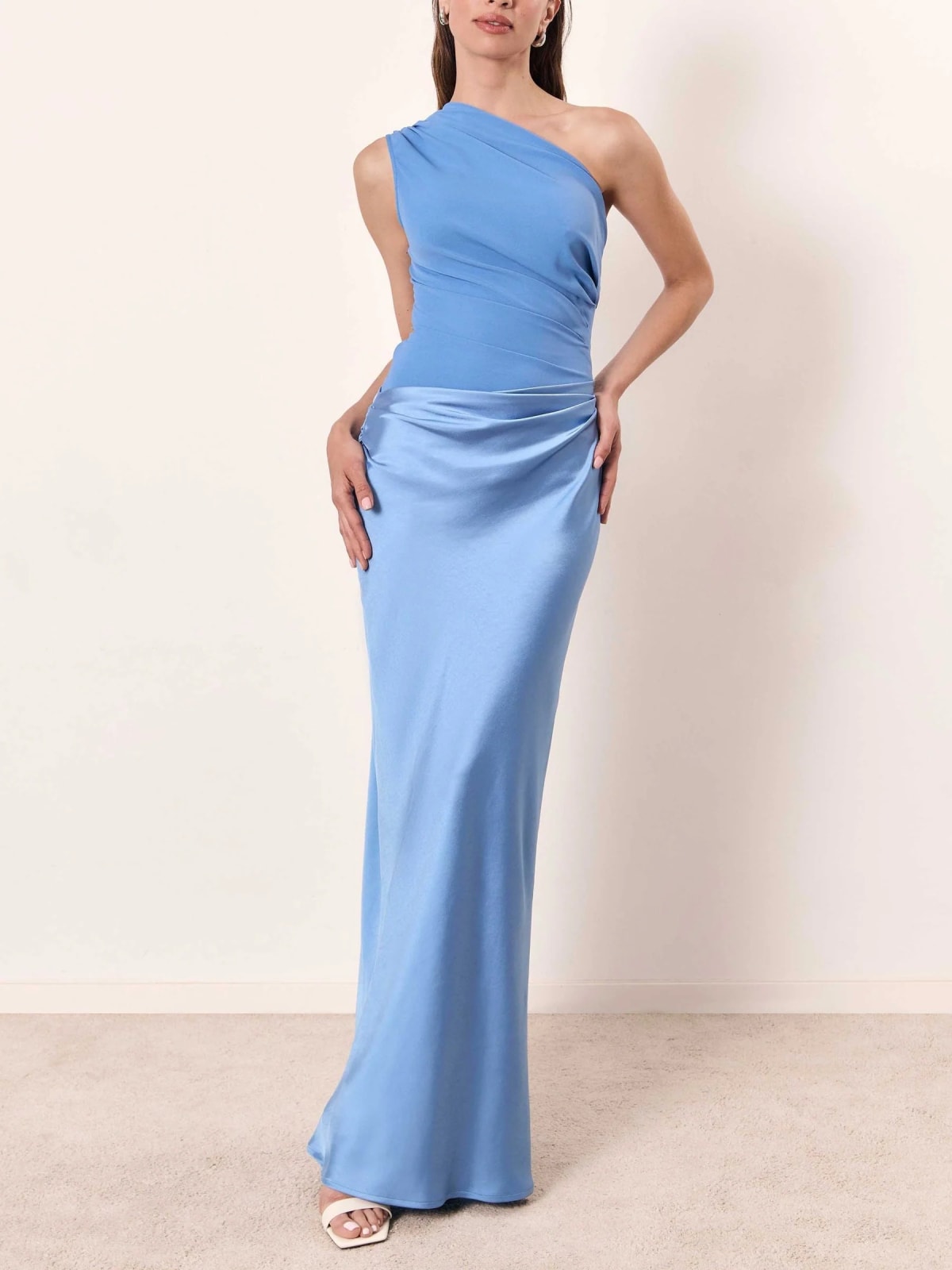 One-shoulder pleated maxi dress with asymmetric neckline.
