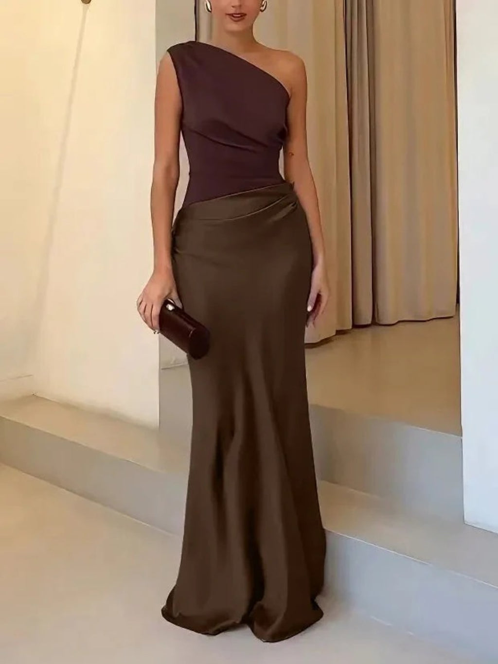 One-shoulder pleated maxi dress with asymmetric neckline.