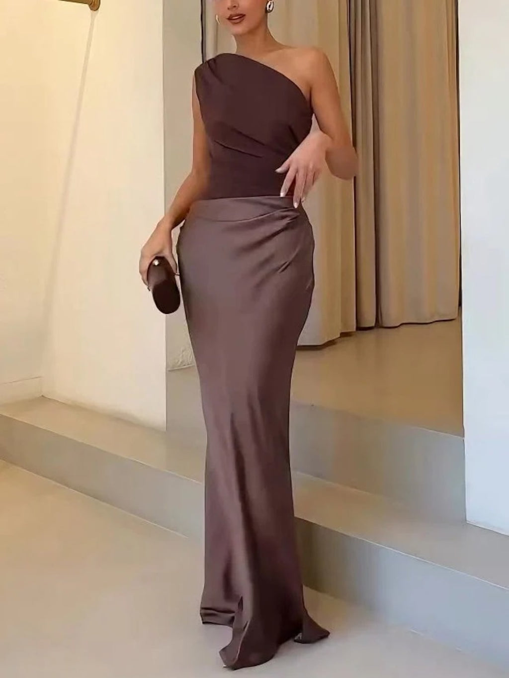 One-shoulder pleated maxi dress with asymmetric neckline.