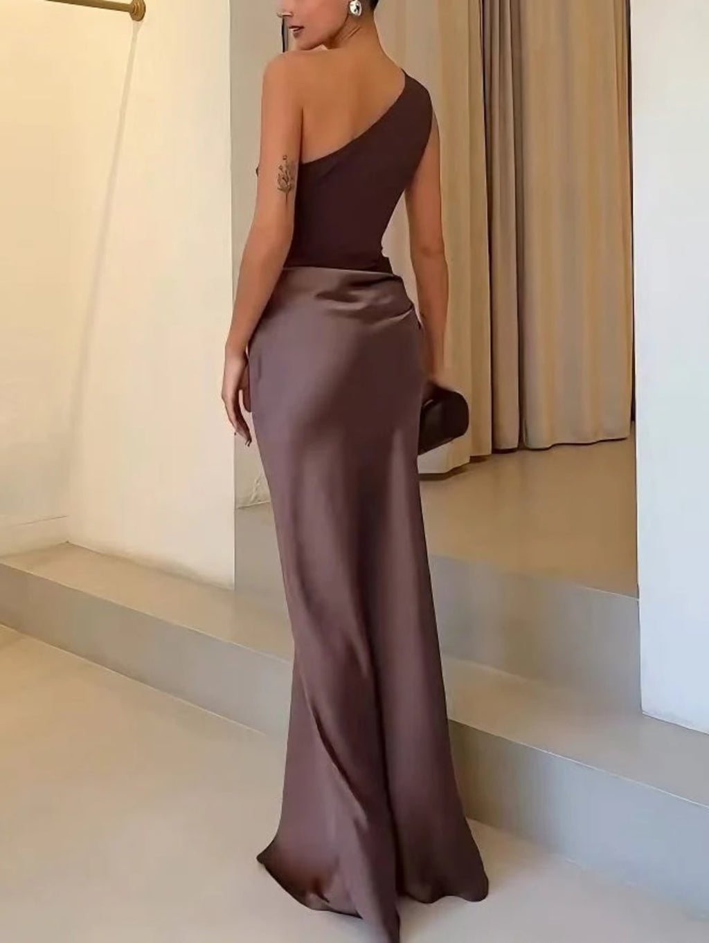 One-shoulder pleated maxi dress with asymmetric neckline.