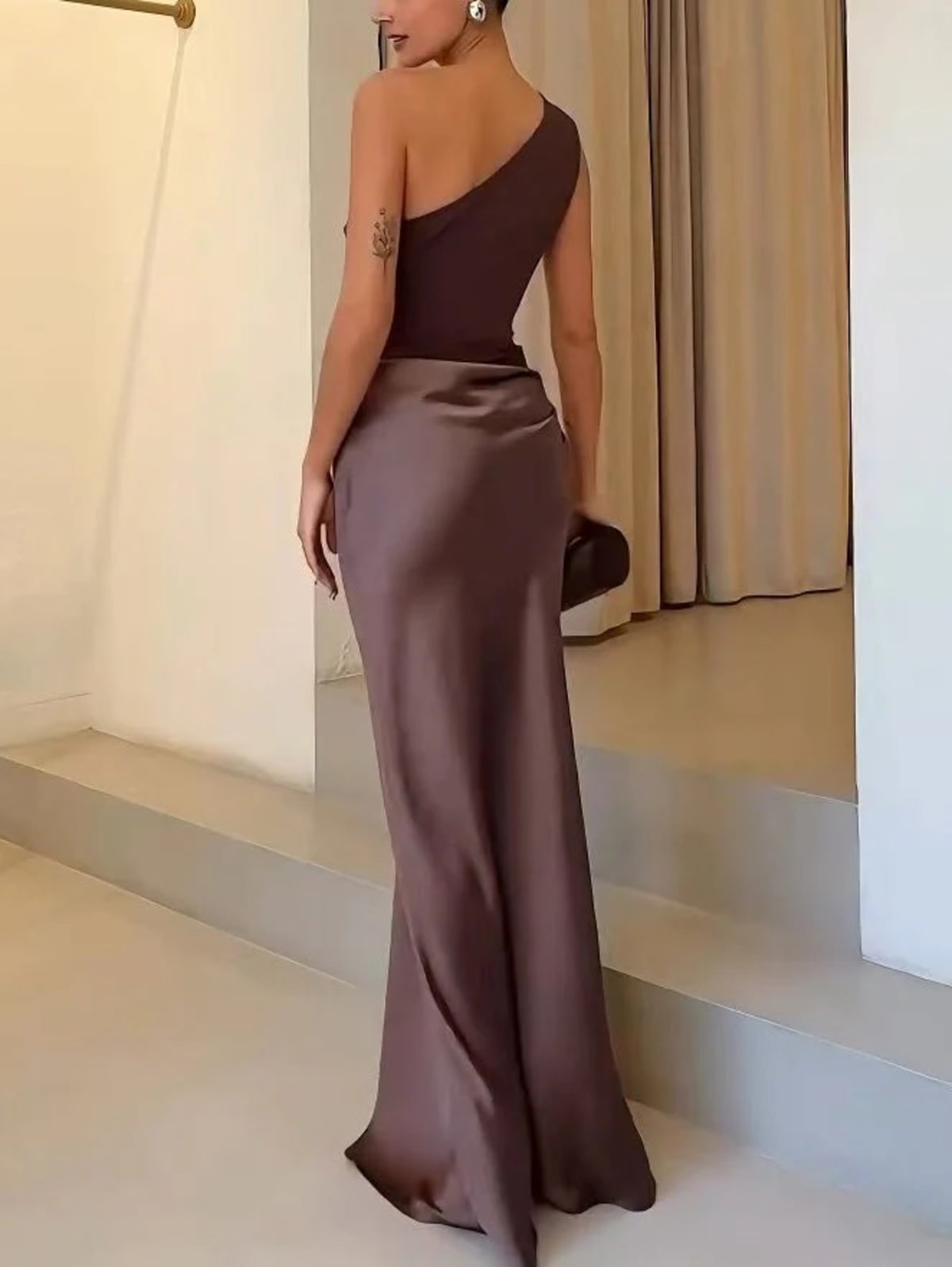 One-shoulder pleated maxi dress with asymmetric neckline.