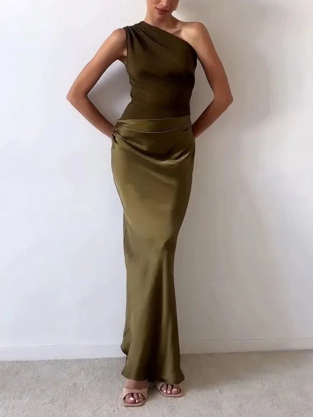 One-shoulder pleated maxi dress with asymmetric neckline.