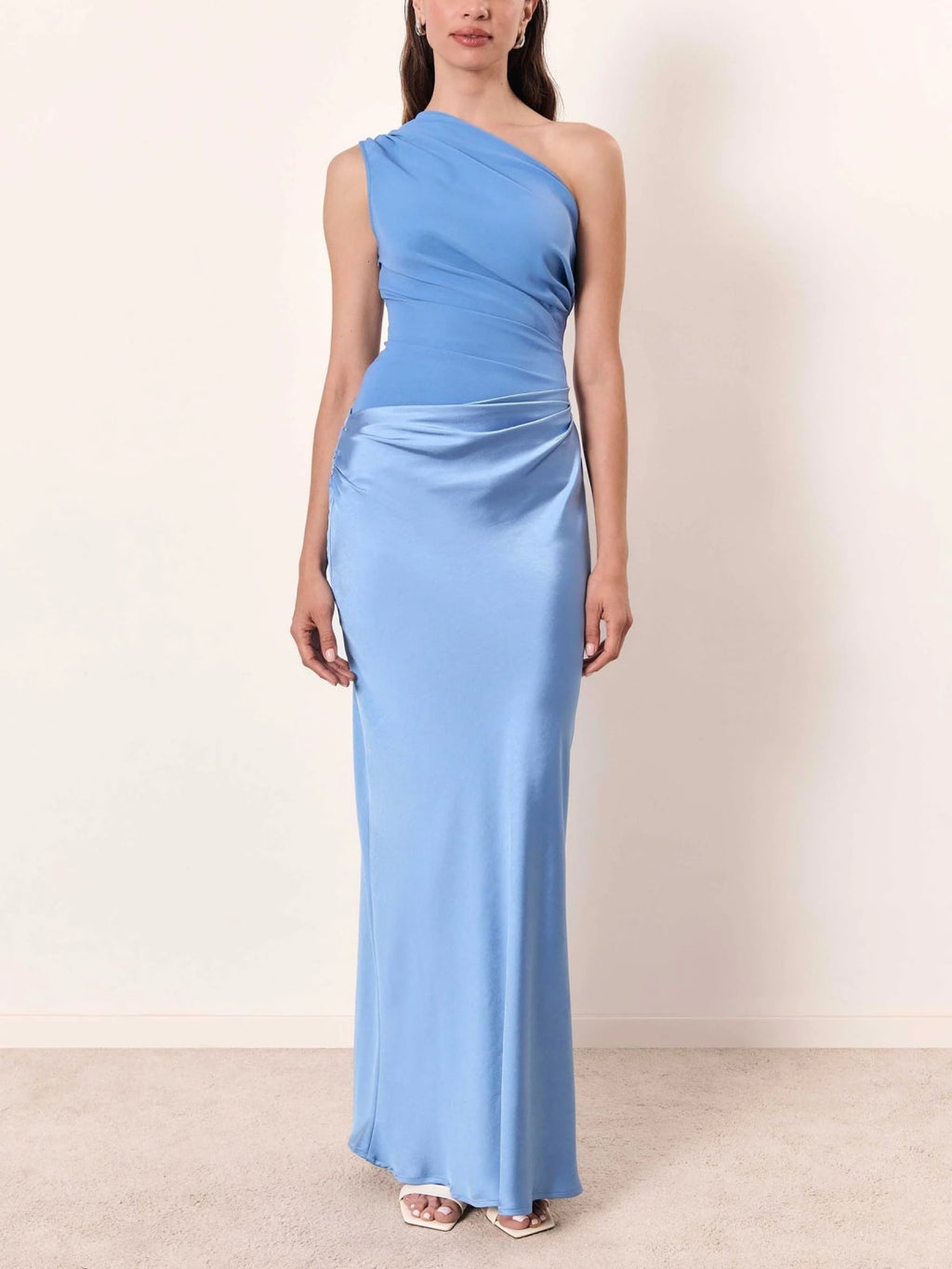 One-shoulder pleated maxi dress with asymmetric neckline.