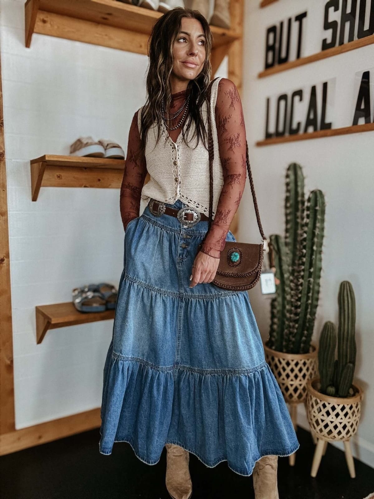 Woman in tiered denim maxi skirt with button-front and off-shoulder top.