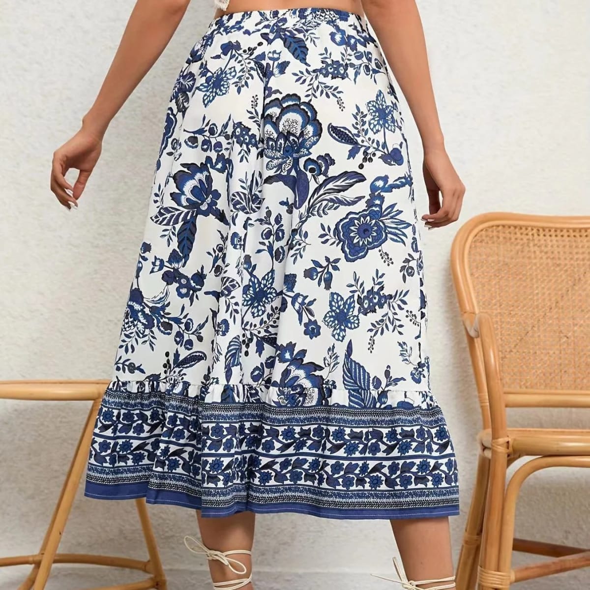 White and blue floral print midi skirt with ruffled hem, modeled with a white crochet halter crop top.