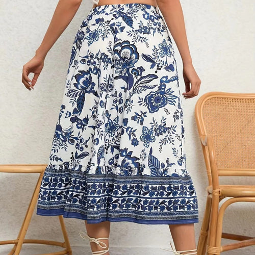 White and blue floral print midi skirt with ruffled hem, modeled with a white crochet halter crop top.
