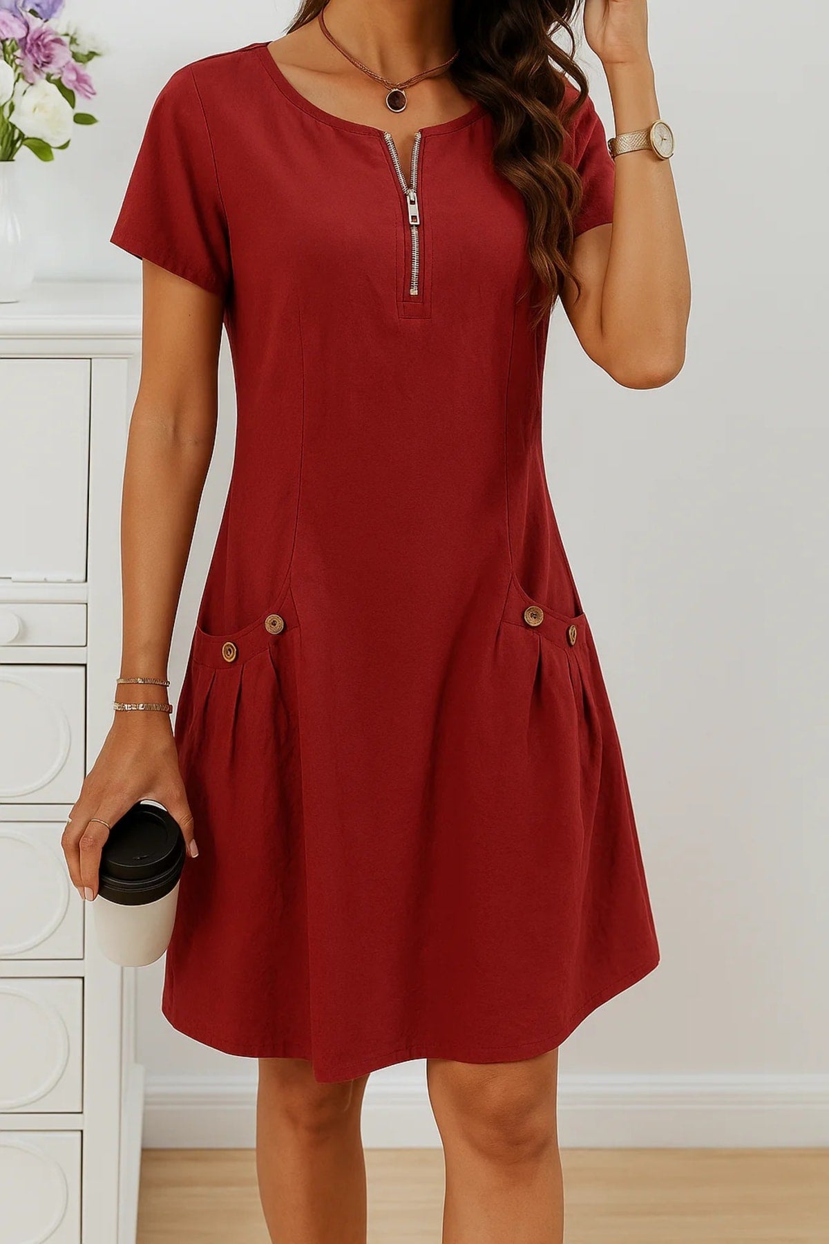 Relaxed fit summer dress with button details and side pockets.