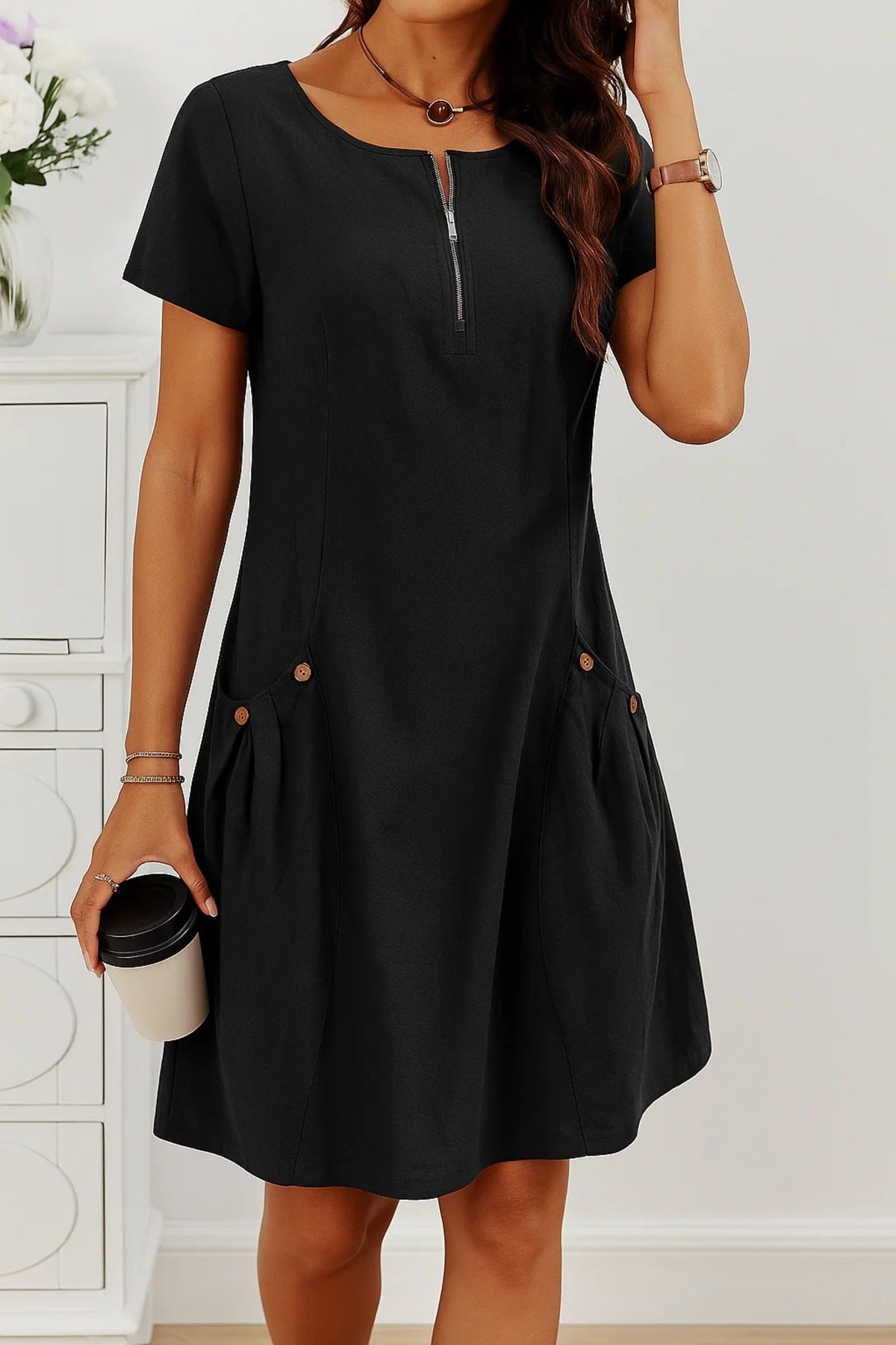 Relaxed fit summer dress with button details and side pockets.