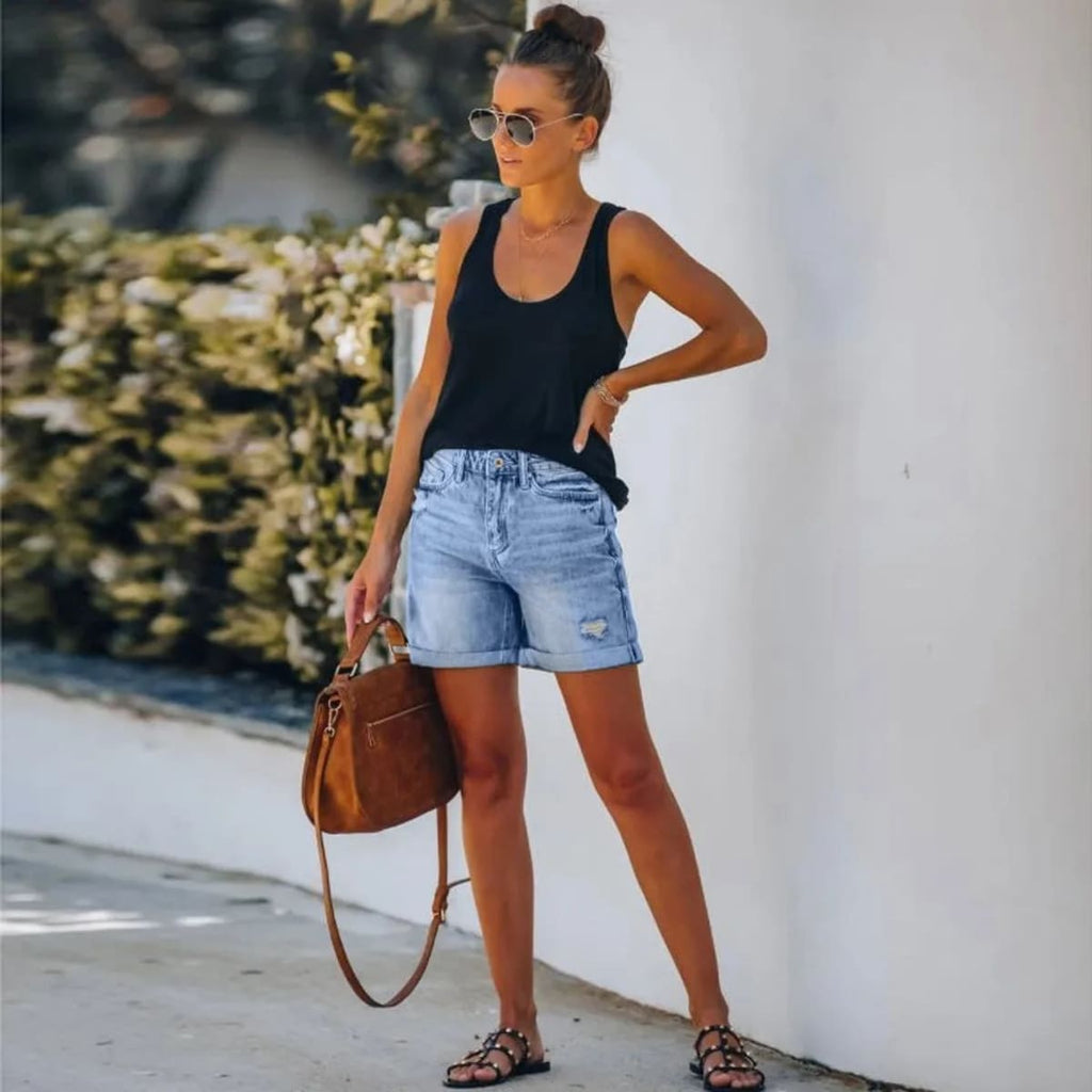 High-waisted denim shorts with distressed rolled hem and pockets.