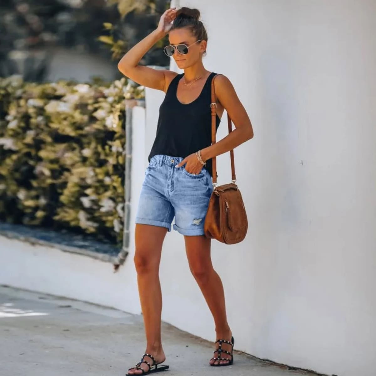 High-waisted denim shorts with distressed rolled hem and pockets.
