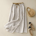 Light beige midi skirt with drawstring waist and embroidery.