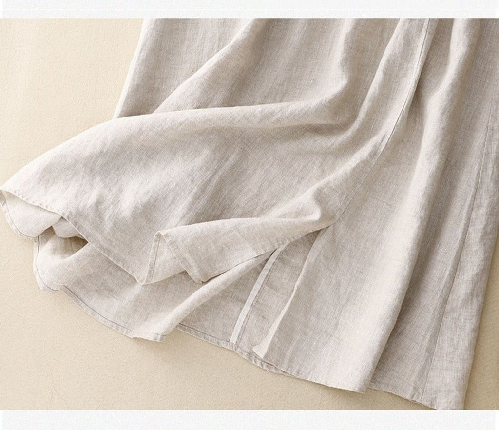 Light beige midi skirt with drawstring waist and embroidery.