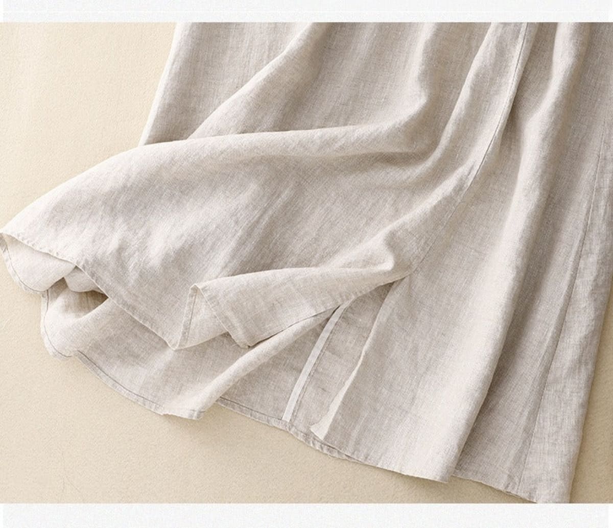 Light beige midi skirt with drawstring waist and embroidery.