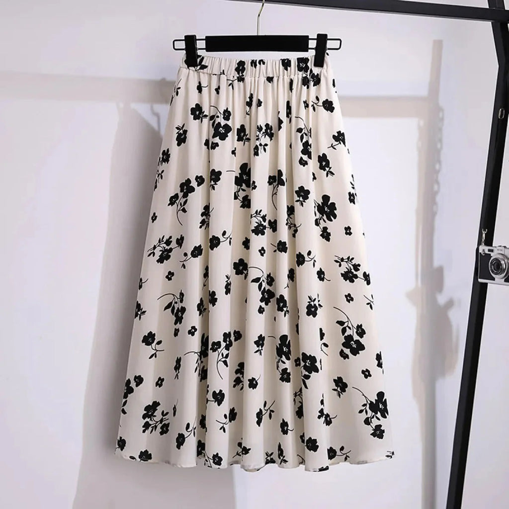 Cream midi skirt with black floral print, elastic waist.