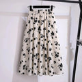 Cream midi skirt with black floral print, elastic waist.