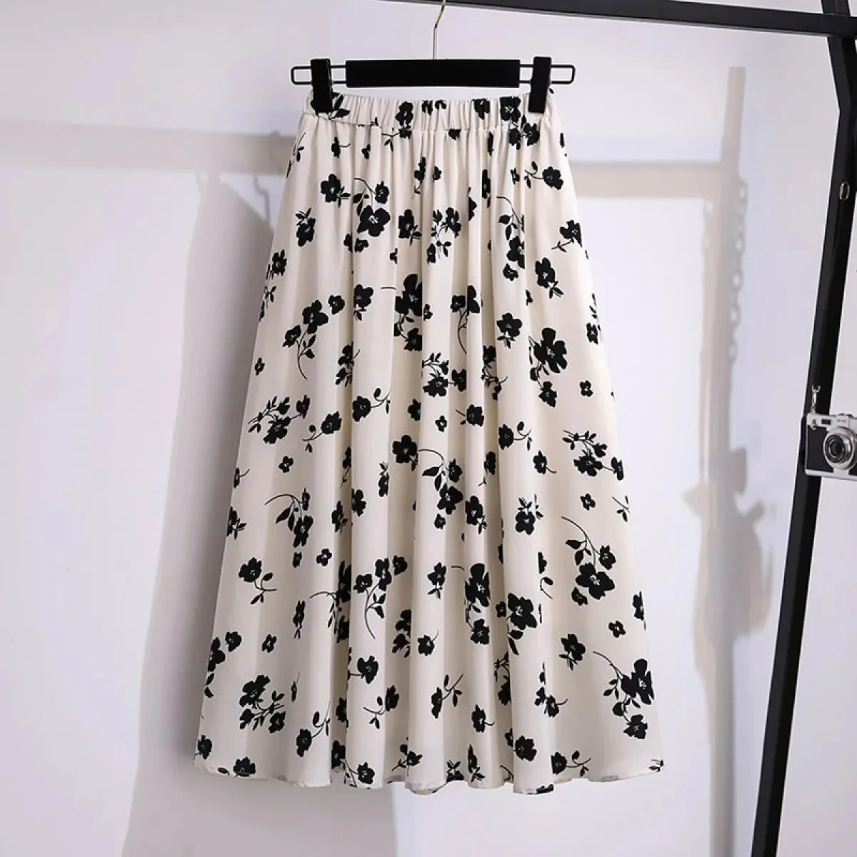 Cream midi skirt with black floral print, elastic waist.